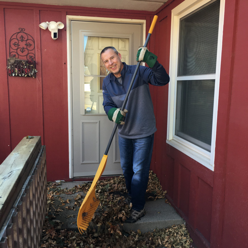 Doug raking a porch